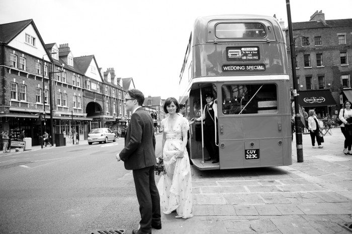 Bride and groom hailing a taxi on the streets of Spitalfields