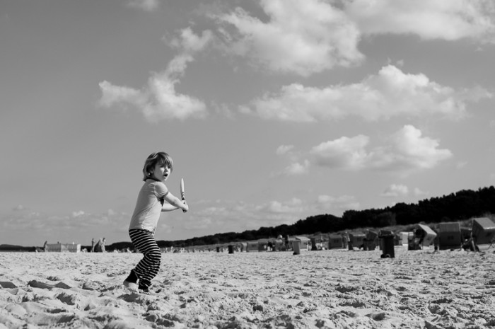 Boy playing cricket on the beach