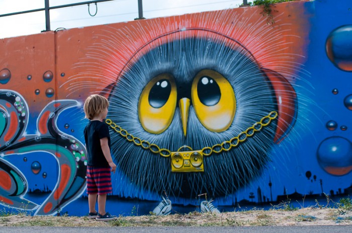 Boy looking at graffiti in Berlin