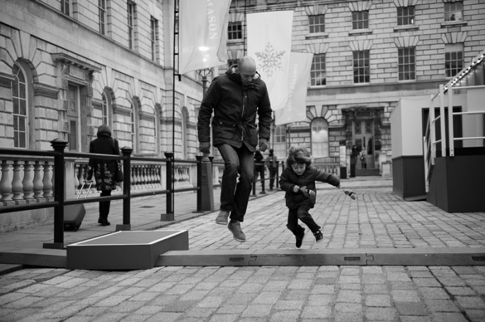 Father and son having fun at Somerset House in London