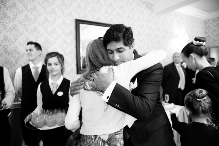 Groom hugging guests at Deans Place wedding