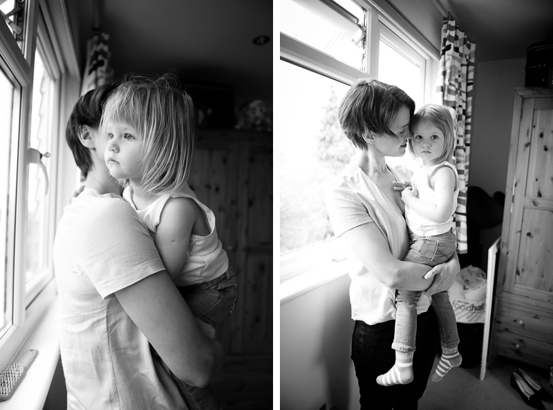Mother and daughter looking out of the window at family portrait session in Palmers Green
