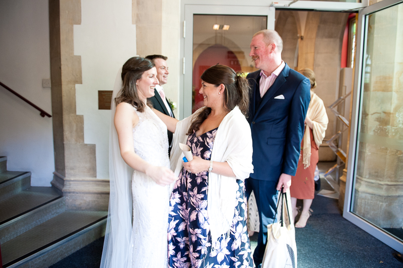 Bride greeting guests at St Pauls church in Ealing