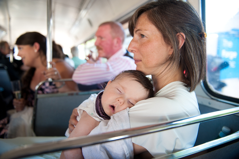 Candid wedding photo of mother and baby on Routemaster bus