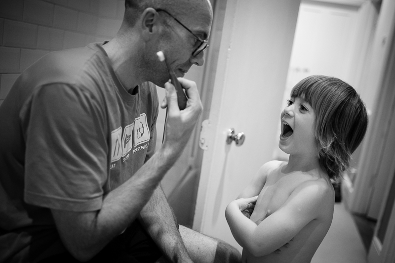 Dad and son brushing teeth