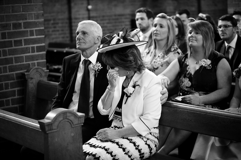 Reportage photograph of mother of the groom crying