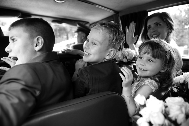 Bridesmaid and flower girls in wedding car