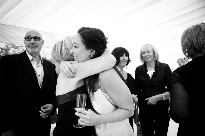Bride hugs guest at Jewish wedding