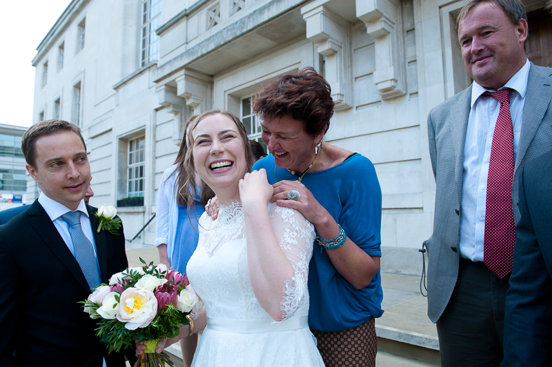 Bride mingling with guests outside Hackney Town Hall