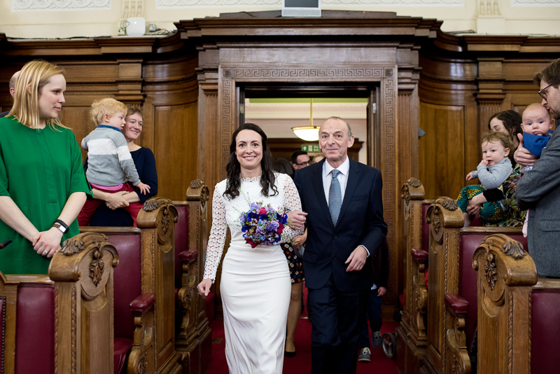 Bride walks down the aisle at Islington Town Hall