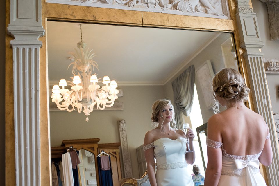 Bride looking in mirror at Anyhoe Park Wedding