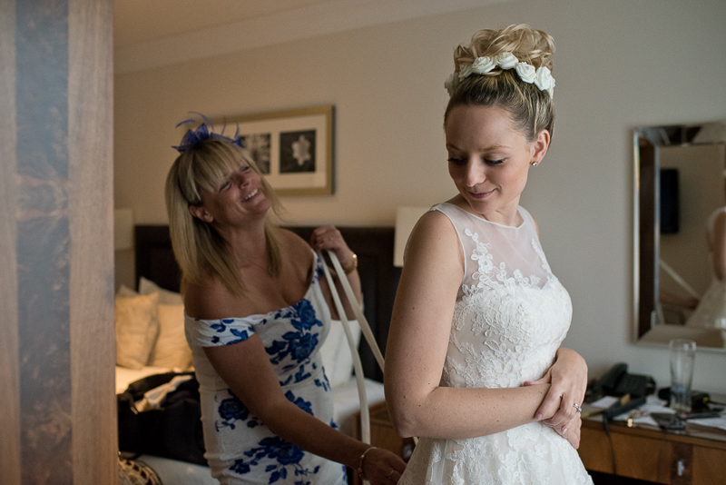 Mum helps bride into dress at Noke Hotel wedding