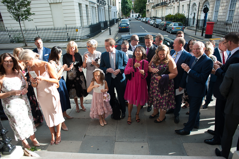Guests greet bride and groom at Asia House after wedding ceremony