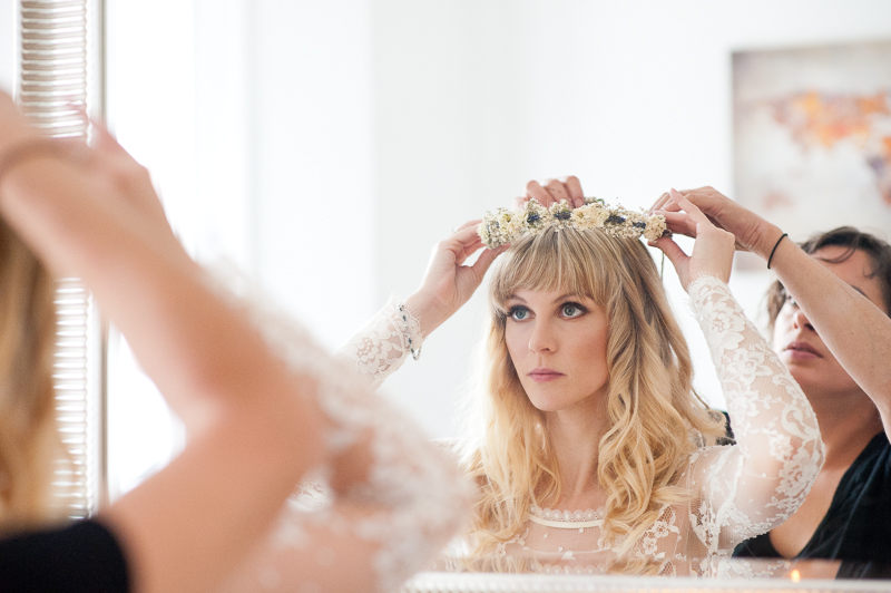 Bride putting on flower crown