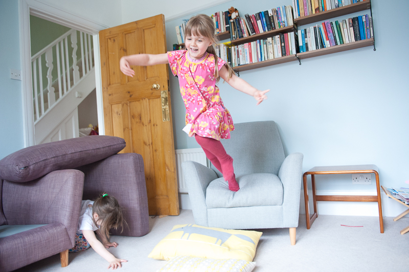 Girl jumping off chair at Palmers Green Family Photography session