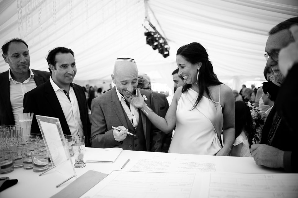Signing the register at Jewish marquee wedding
