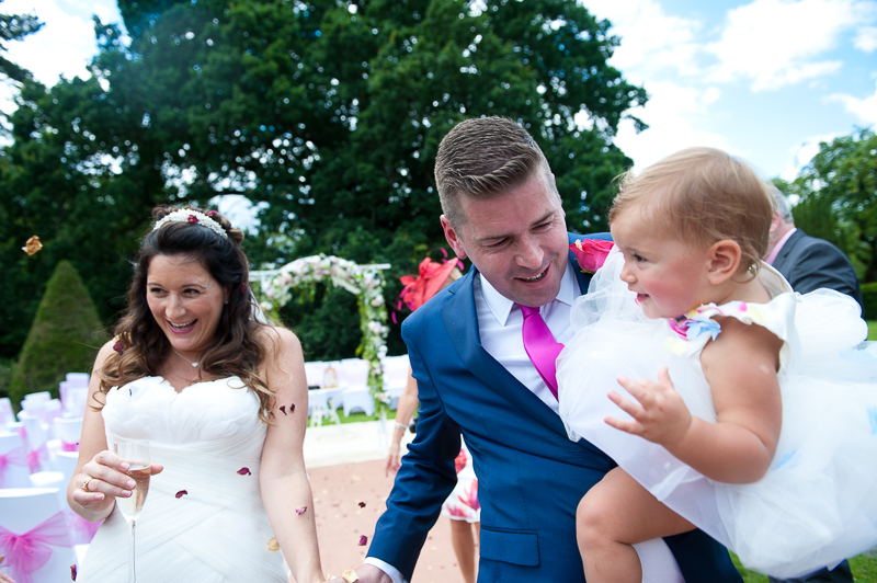 Bride, groom and daughter at outdoor wedding ceremony at Ridge Farm
