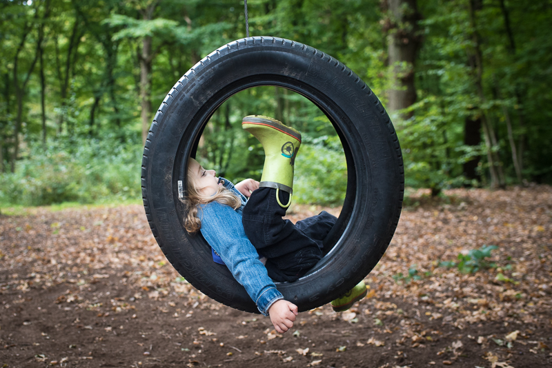 Girl on tyre swing in Coppetts Wood
