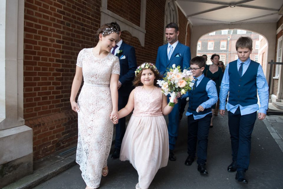 Bride and flower girl walk to gardens at Gray's Inn wedding