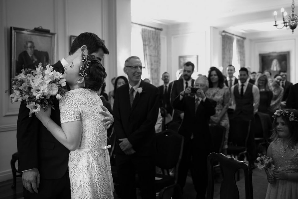 Bride and groom hug at wedding ceremony at Gray's Inn