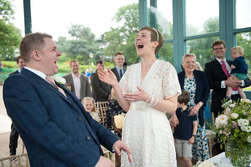 Bride and groom laugh at Horniman bandstand wedding
