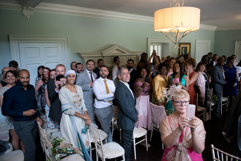 Guests await black bride at Morden Hall wedding