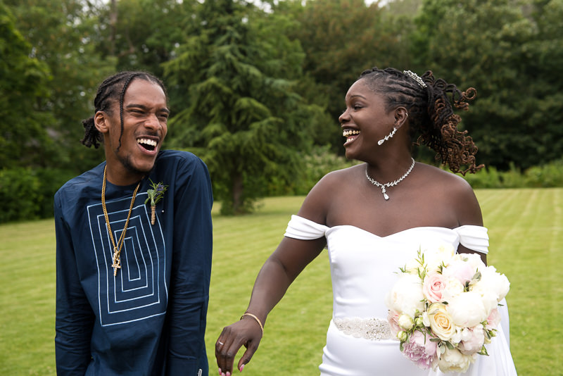 Bride laughs with guests at Morden Hall wedding