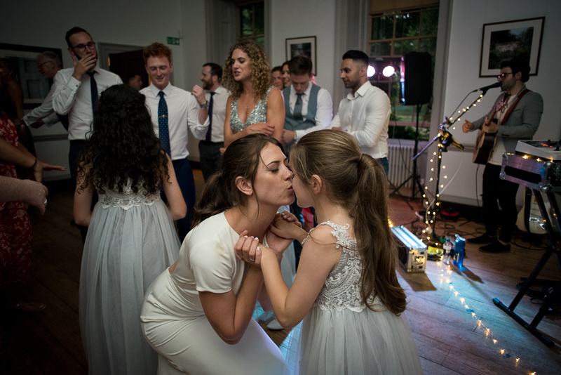 Bride kisses flower girl at Fulham Palace wedding