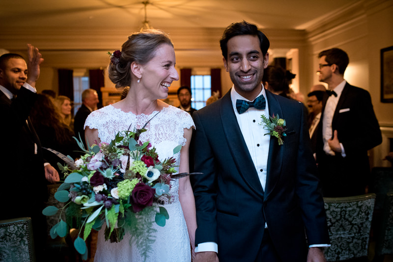 Bride and groom smile during wedding ceremony at The Ned hotel