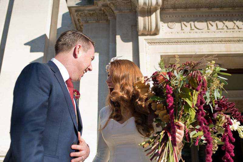 Bride and groom on the steps of Islington Town Hall