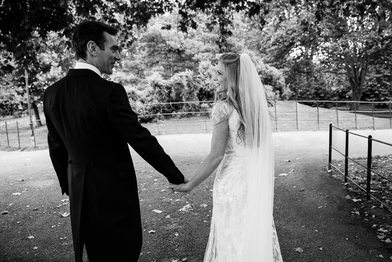 Black and white couple photo of bride and groom in Battersea Park near St Mary's Church