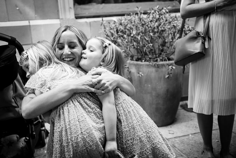 Bride hugs flower girls