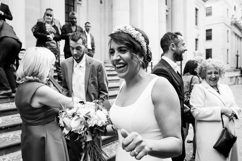 Bride greets guests at Old Marylebone Town Hall