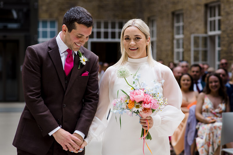 Bride and groom during ceremony in the Atrium at Hackney Town Hall wedding